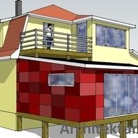 Ein Haus mit roter und gelber Fassade sowie einem Balkon, das einladend und farbenfroh wirkt.